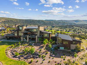 Contemporary multi-level residence featuring extensive stone and wood-paneled exterior finishes