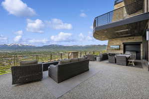 Spacious outdoor terrace with a concrete aggregate surface and a built-in linear fire pit