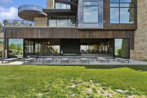 Multi-level modern exterior featuring natural wood siding and stone accents