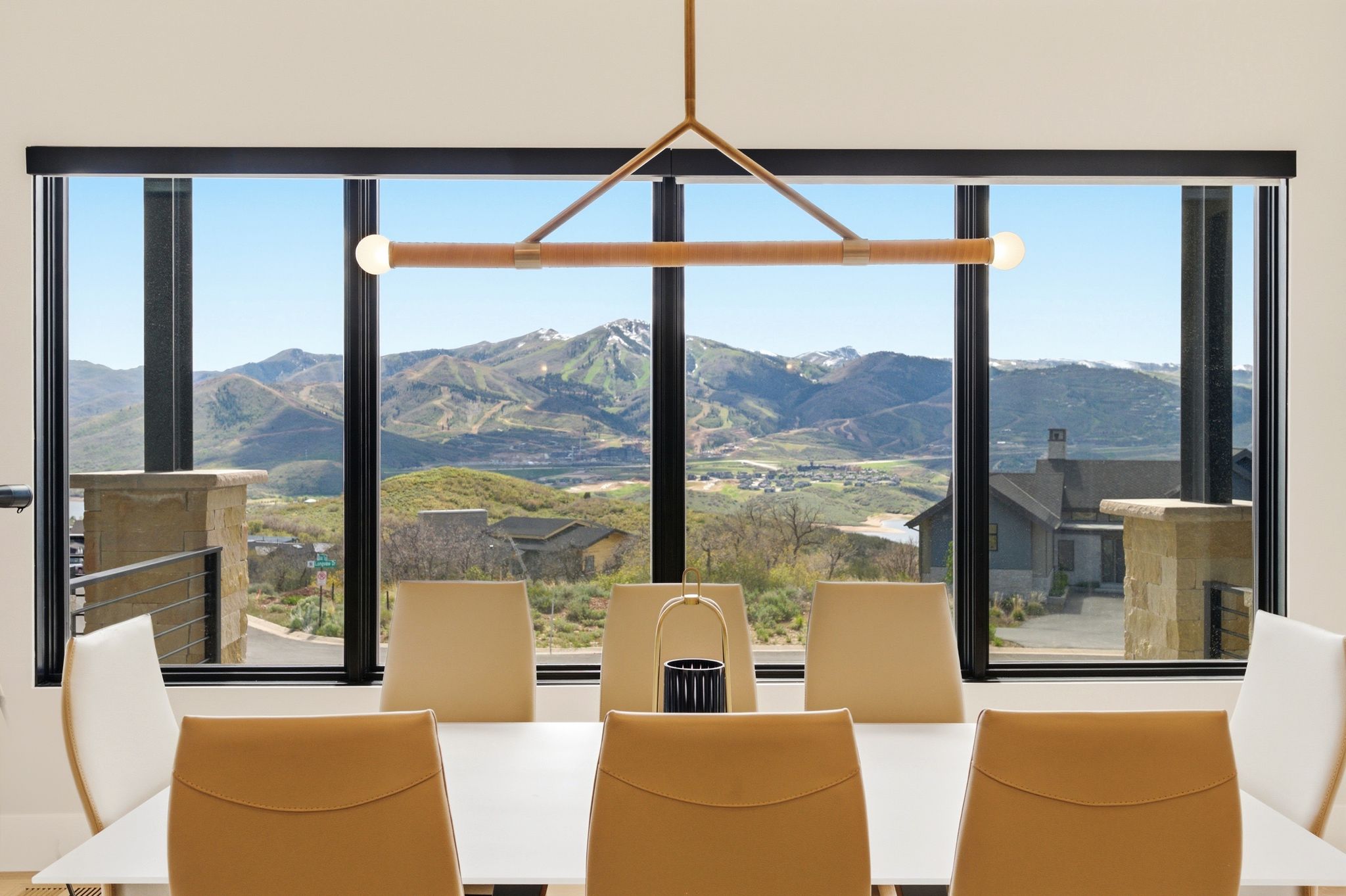 Dining area with broad window framing distant mountains and community
