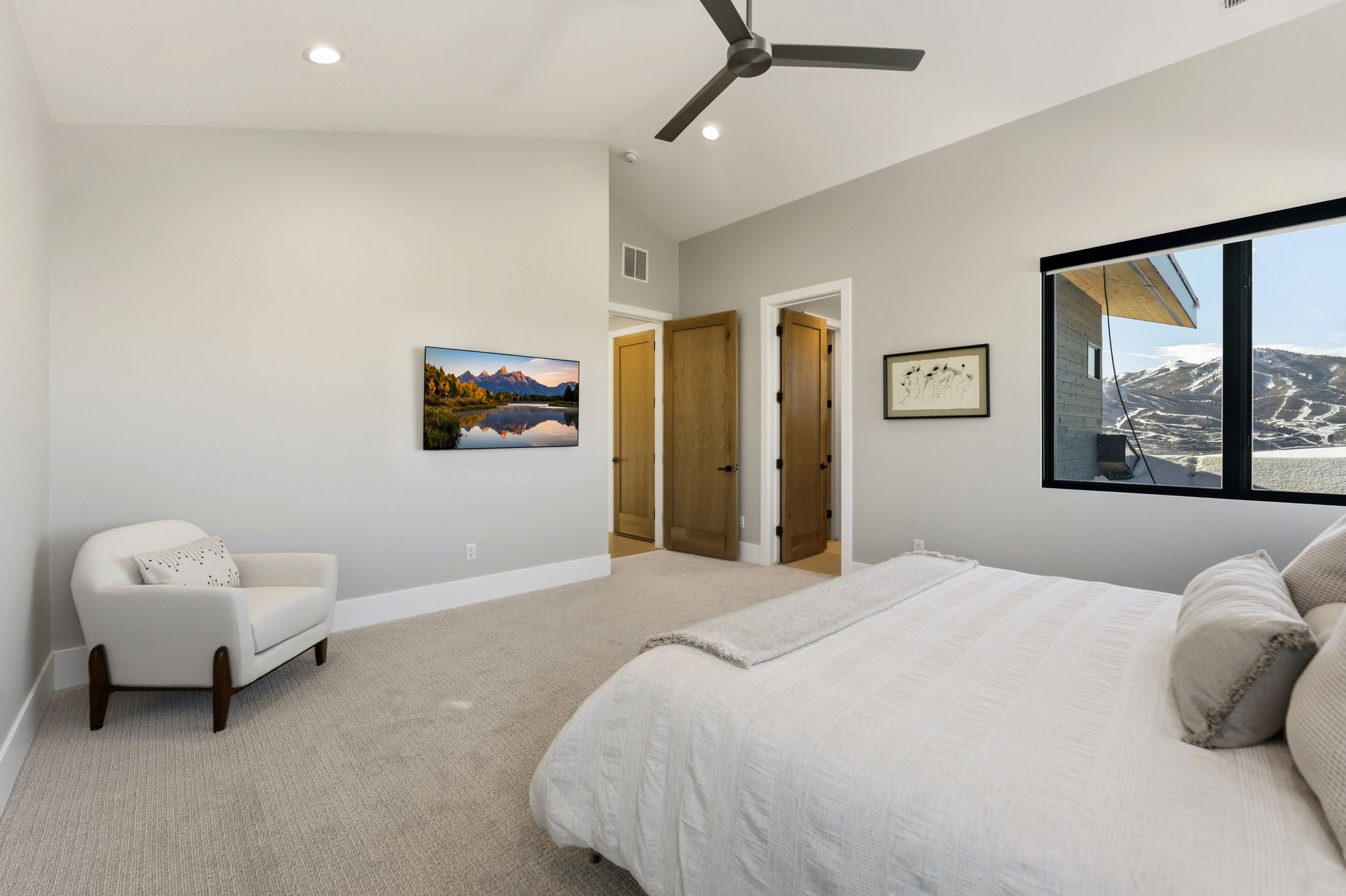 Carpeted room featuring a vaulted ceiling with recessed lighting and a ceiling fan