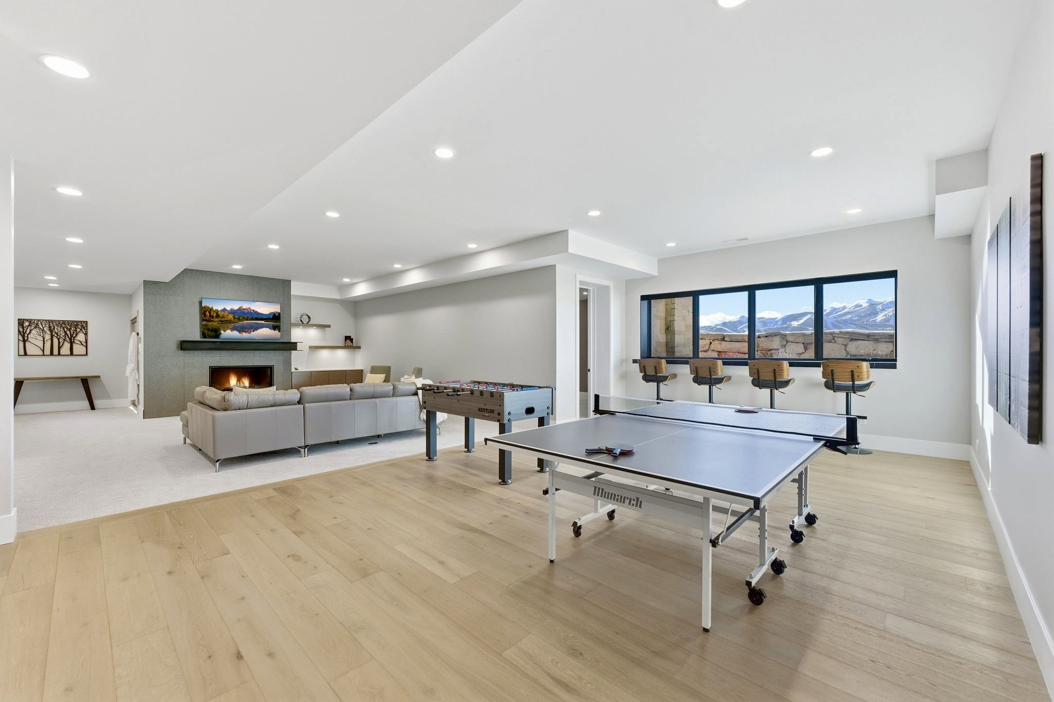 Open-concept lower level with natural light wood-finish flooring