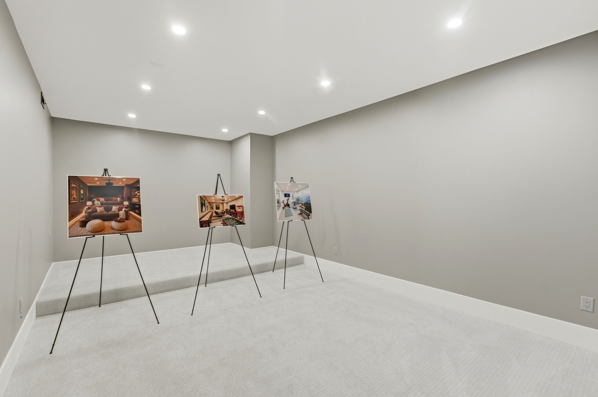 Spacious room featuring light gray walls, white trim, recessed lighting, and light-colored carpeted flooring