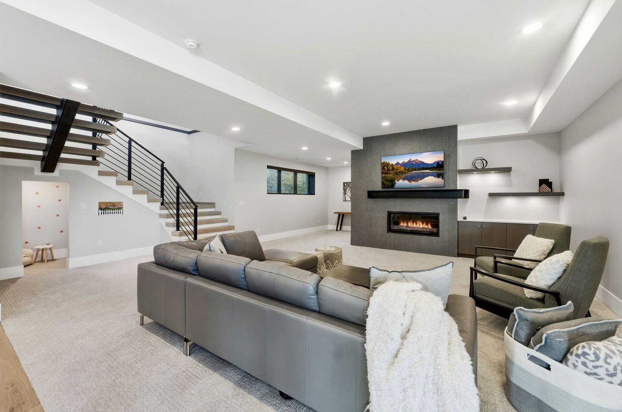 Expansive living area featuring a modern fireplace with a dark stone-look surround and built-in media console
