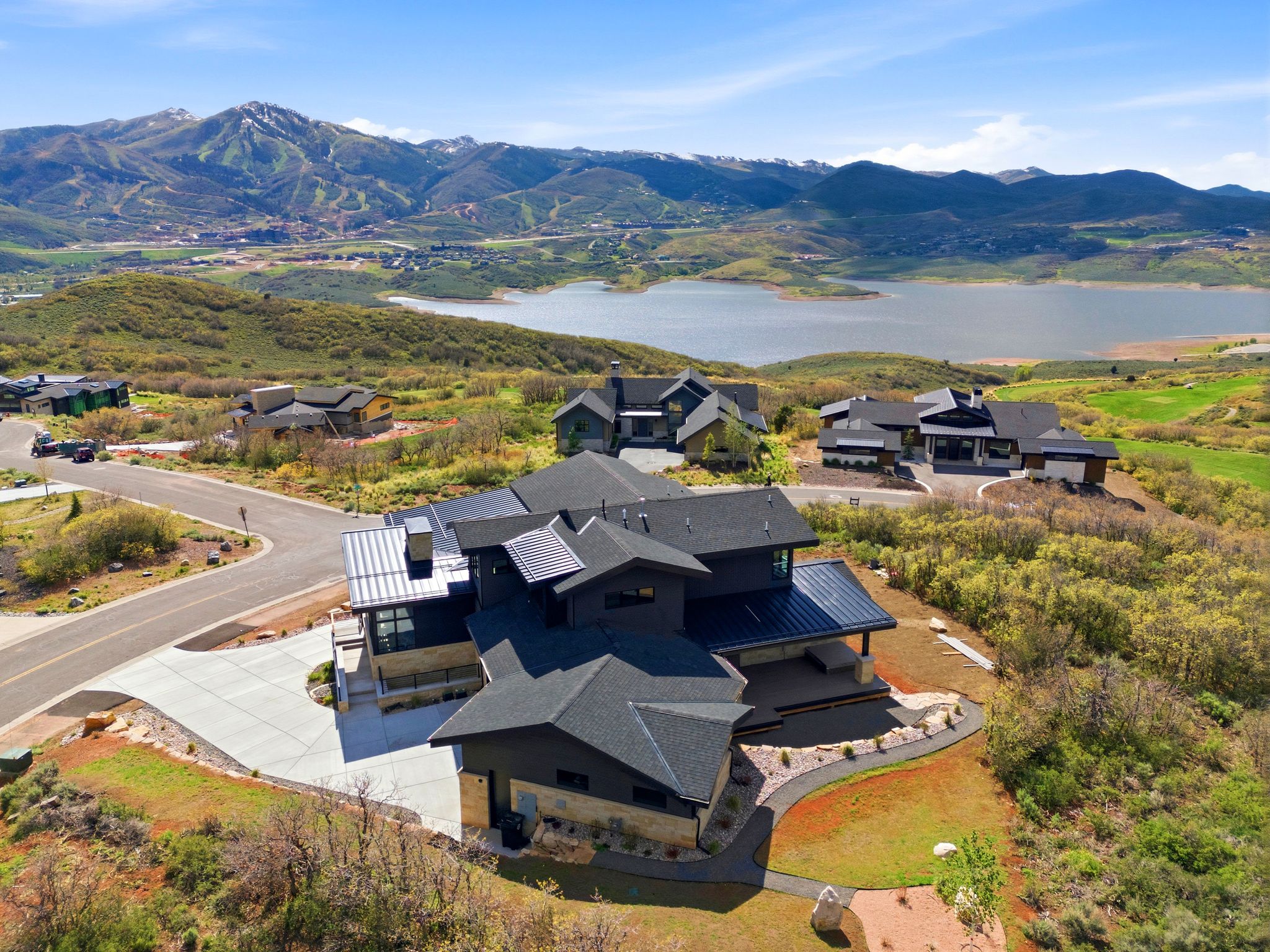 Contemporary multi-level residence featuring a dark-toned exterior with stone accents and multiple rooflines