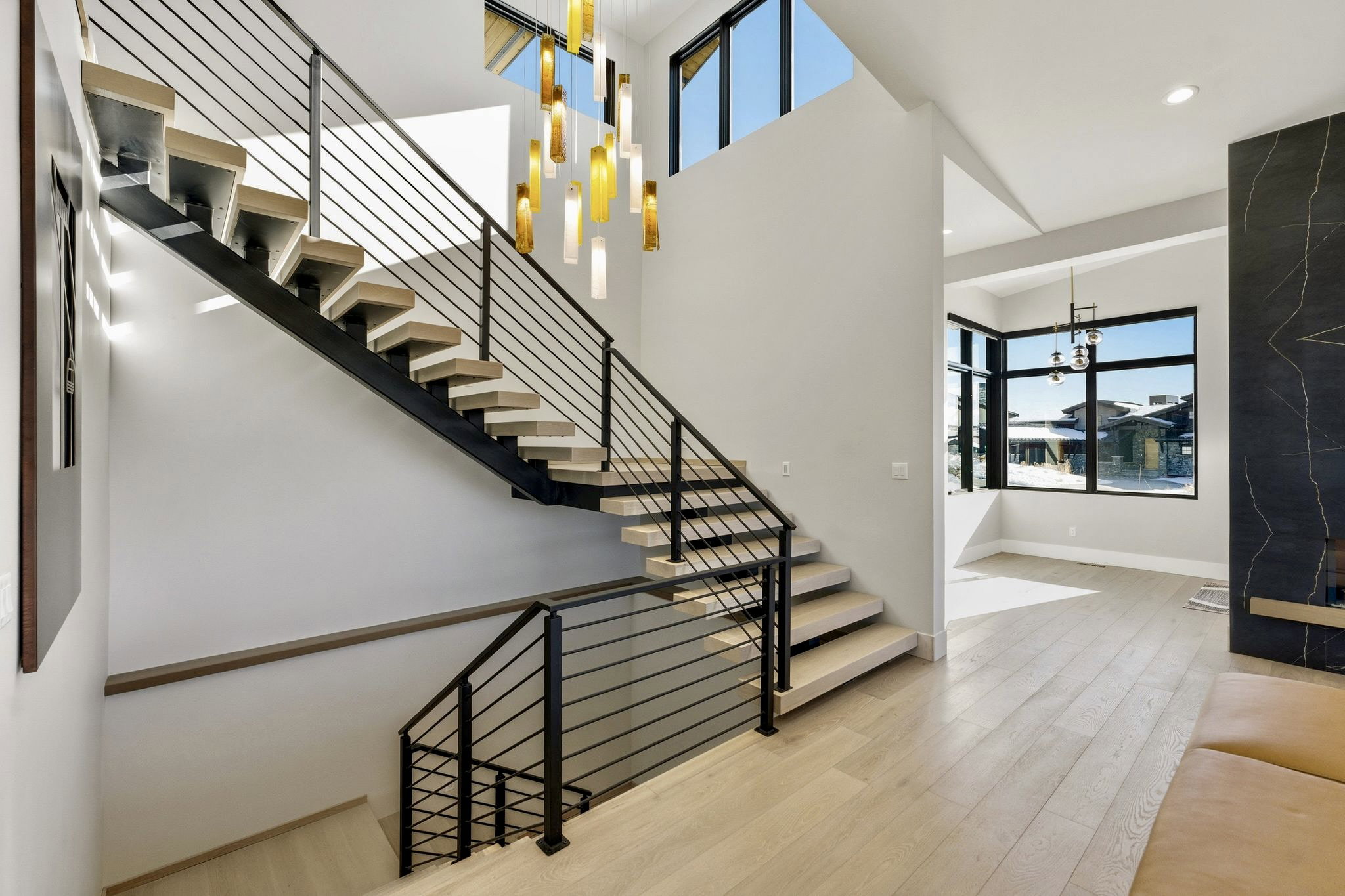Floating staircase with wood-finish treads and metal railings