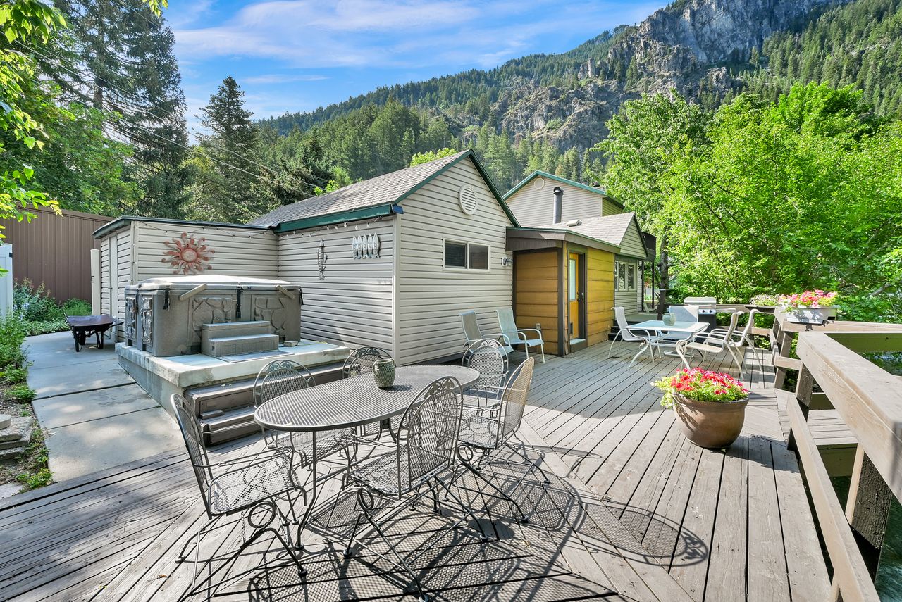 Expansive exterior wood deck with a built-in spa on a concrete pad