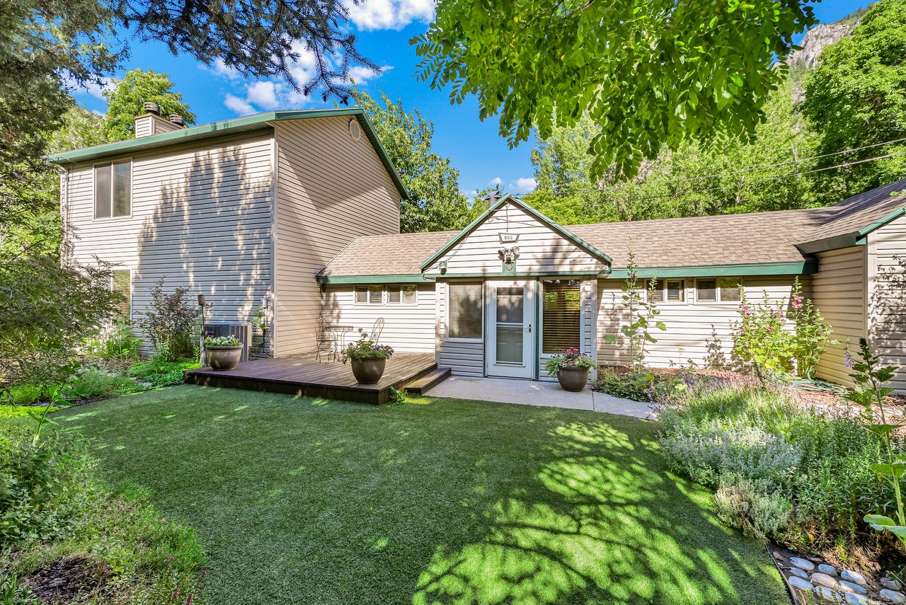 Exterior featuring light-toned siding, a multi-level design, and a gabled entry