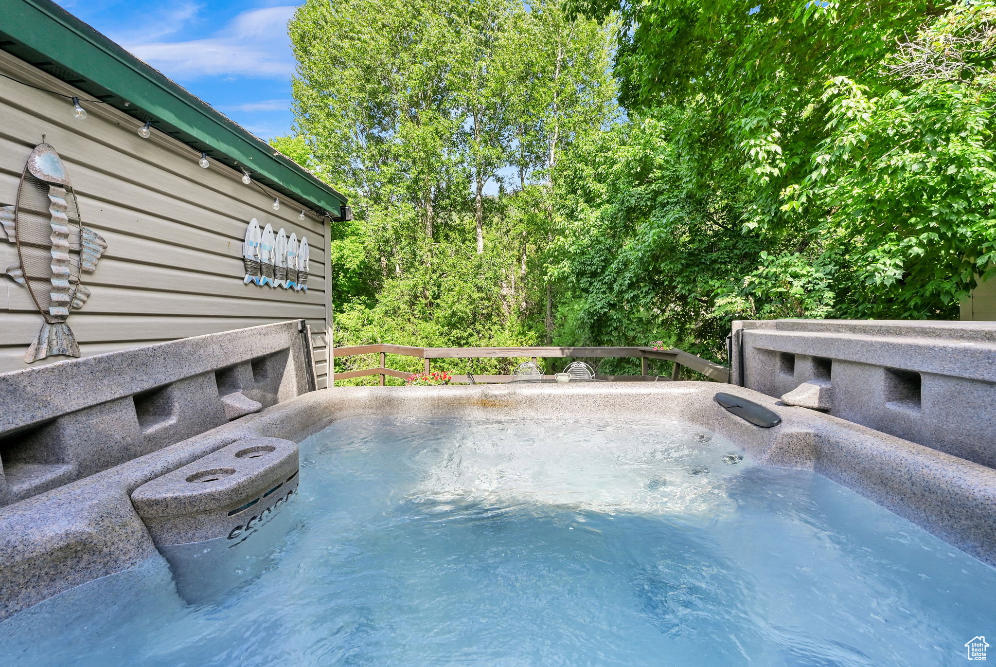Outdoor spa with bubbling water, set against a backdrop of mature trees