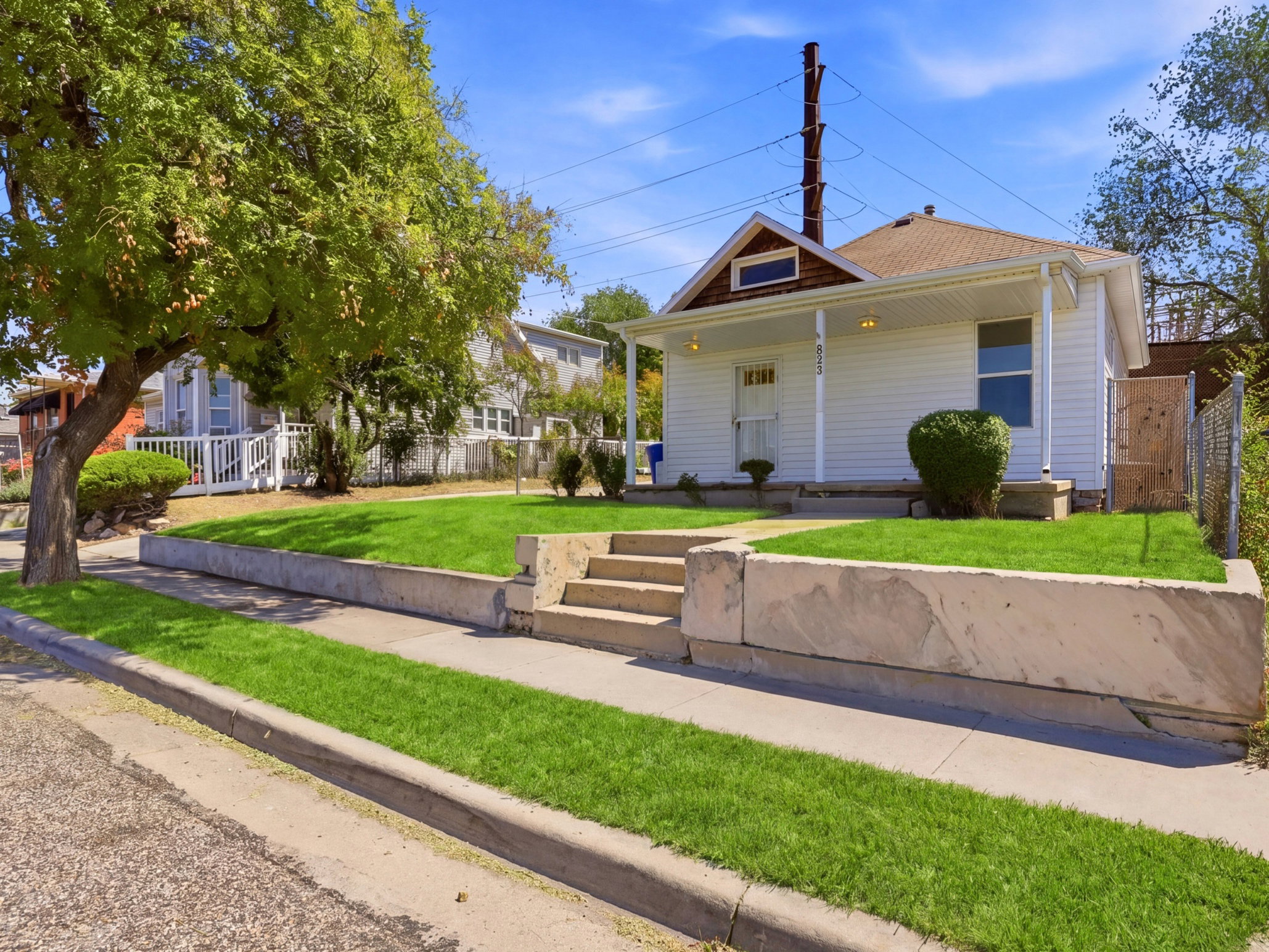 White exterior featuring a covered front porch with pillar supports