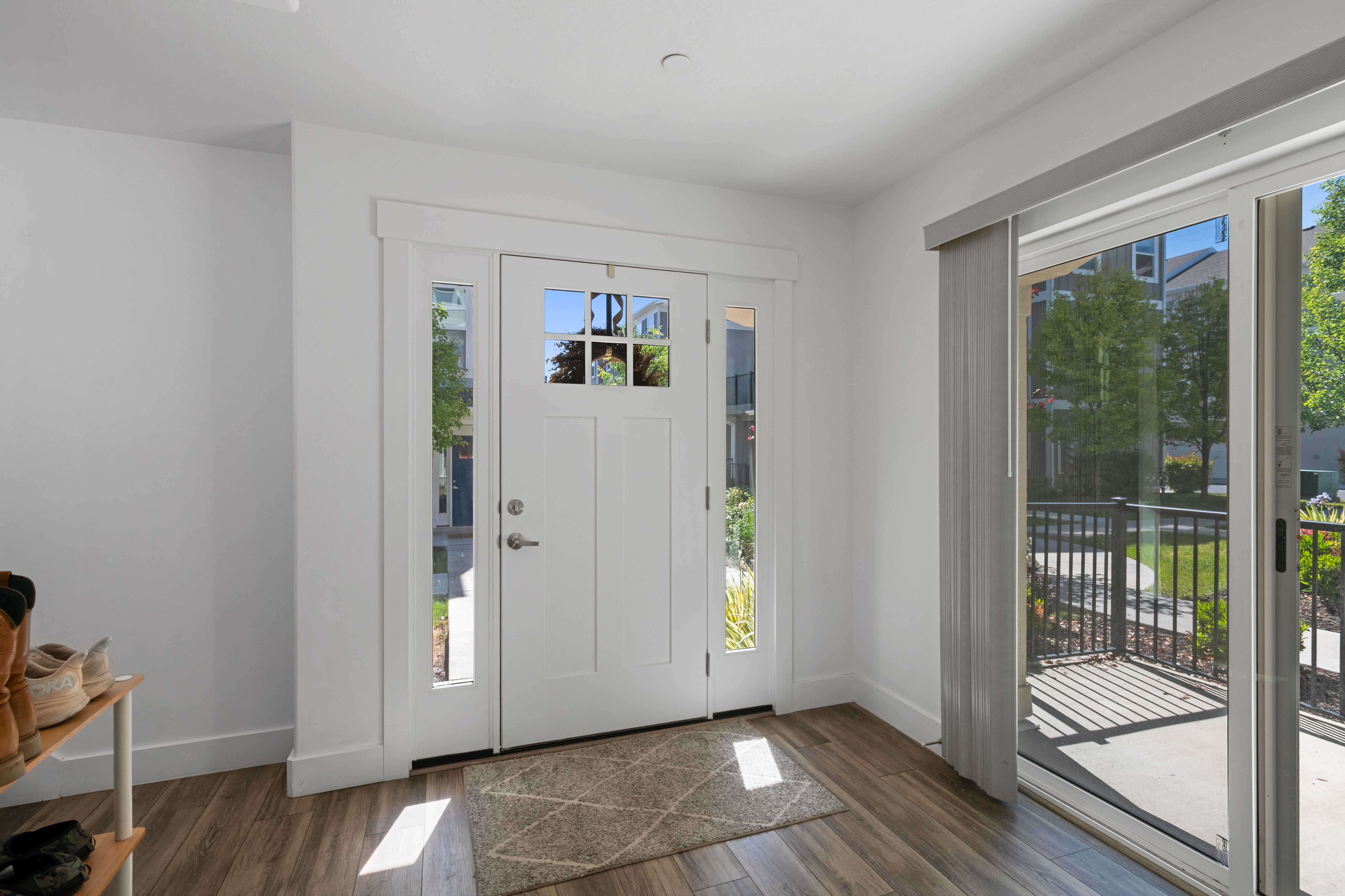 Entryway featuring a paneled front door with decorative glass, side lites, and transom window