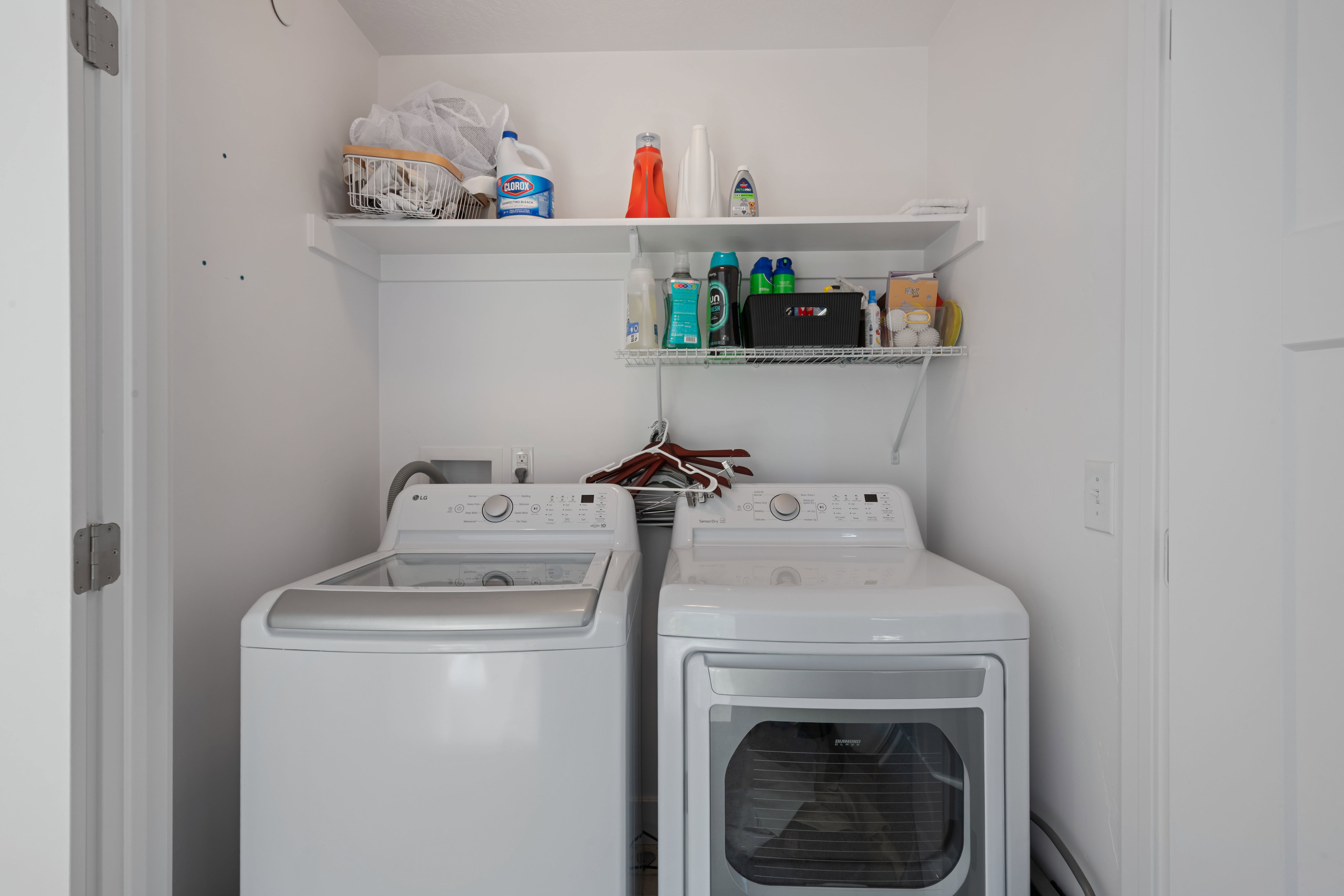 Dedicated laundry area featuring a white top-load washer and a white front-load dryer