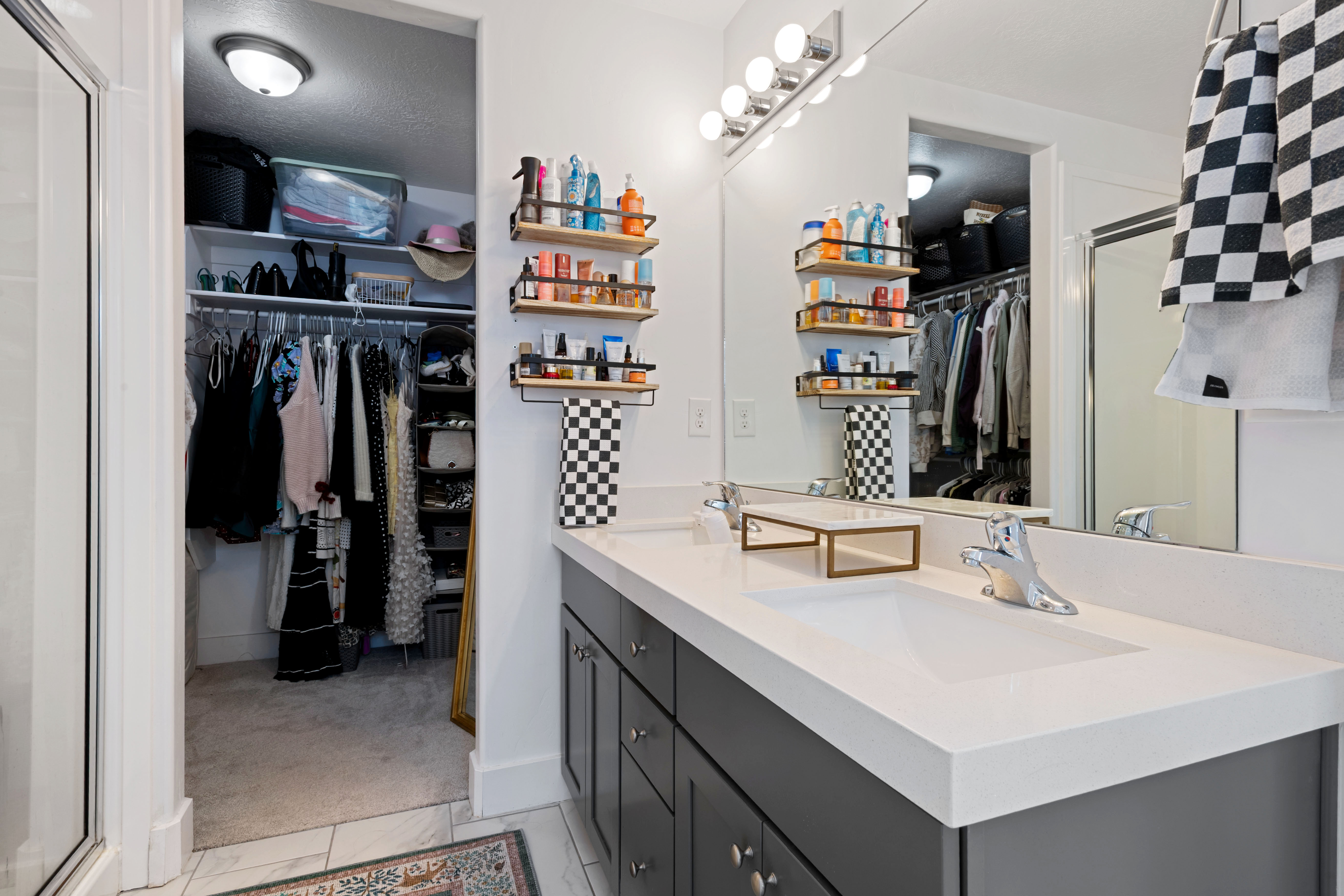 Double vanity with integrated sinks, white countertop, and brushed nickel faucets
