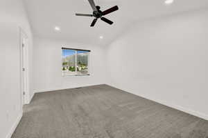 Spacious room featuring vaulted ceilings, recessed lighting, and a contemporary ceiling fan