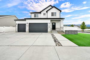 Modern two-story residence featuring white siding and black trim accents