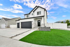 Contemporary two-story residence featuring white siding with black trim accents