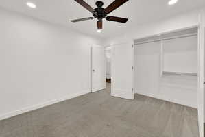 Bedroom featuring gray carpet flooring, white walls, recessed lighting, and a dark wood-finish ceiling fan