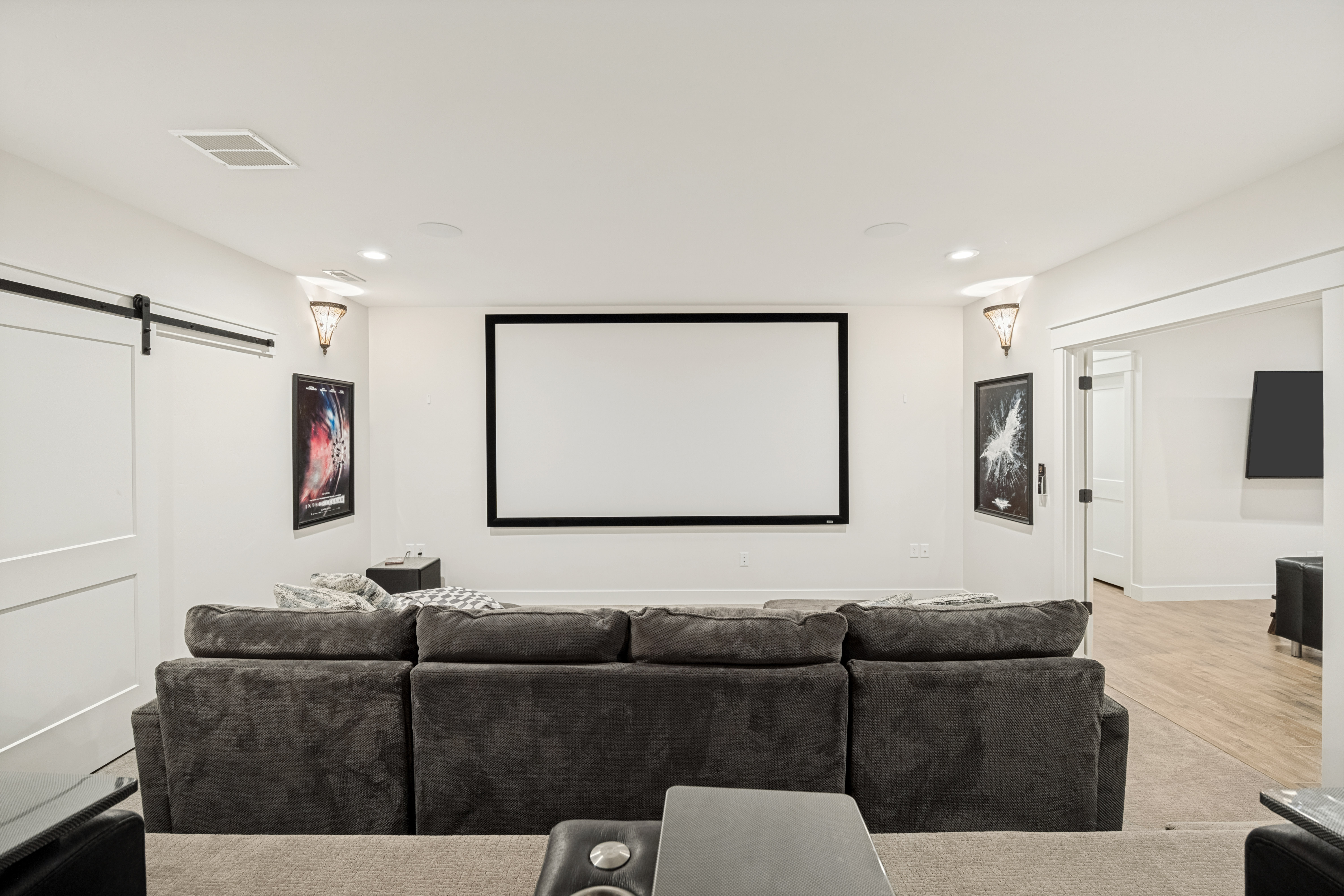 Dedicated media room featuring a large projector screen