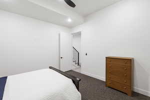 Bedroom featuring recessed lighting, dark carpet flooring, and a modern ceiling fan