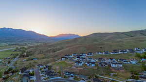 Aerial perspective showcasing a residential development set against a backdrop of rolling hills and distant mountains