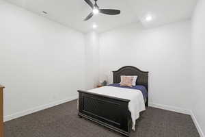 Interior room with white walls, dark gray carpet, a black ceiling fan, and recessed lighting