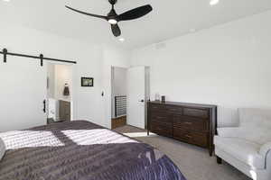 Spacious bedroom featuring a modern ceiling fan, recessed lighting, white walls, and gray carpet flooring