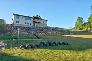 Expansive lawn area with a terraced rock retaining wall