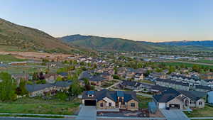 Residential neighborhood featuring a mix of single-family homes and townhomes with mountain backdrop