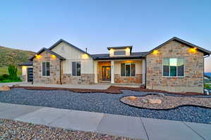 Modern ranch-style home featuring a stone and board-and-batten exterior