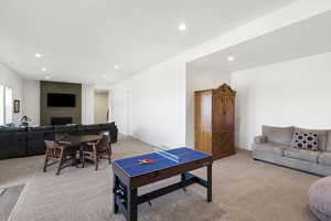 Spacious recreation room featuring recessed lighting and neutral-toned carpeting throughout