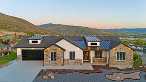 Modern farmhouse-style home with stone and vertical siding accents