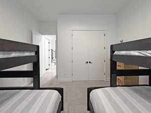 Carpeted room featuring dual white paneled doors with contemporary black hardware