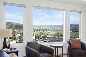 Multiple large windows frame expansive mountain and valley scenery
