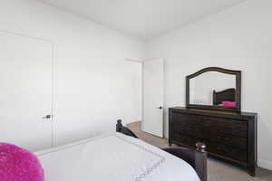 Spacious room featuring light-toned walls, recessed lighting, and soft carpeting