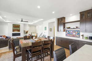 Open-concept living space with a formal dining area, recessed lighting, and wood-finish flooring