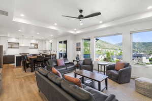 Expansive living area featuring wood-finish flooring, recessed lighting, and large windows