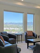 Expansive windows framing a distant mountain range and cityscape