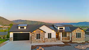 Ranch-style residence featuring a mixed-material facade with stone veneer and vertical white siding