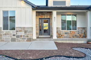 Exterior showcasing stone and board-and-batten siding