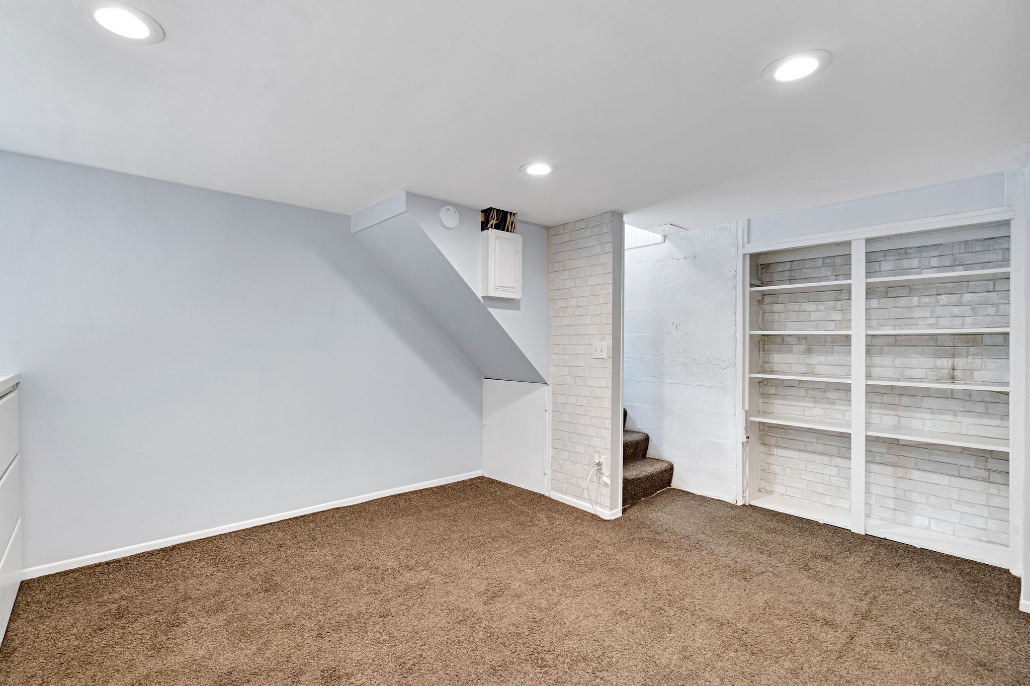 Carpeted interior space featuring recessed lighting and light blue wall color