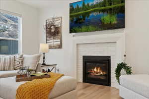 White-painted brick fireplace with a black firebox and a clean-lined mantel