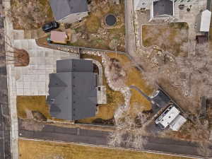 Modern residential property with a dark shingle roof and a concrete driveway