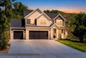 Modern two-story residence featuring a combination of light-toned siding, dark vertical siding accents, and white brick