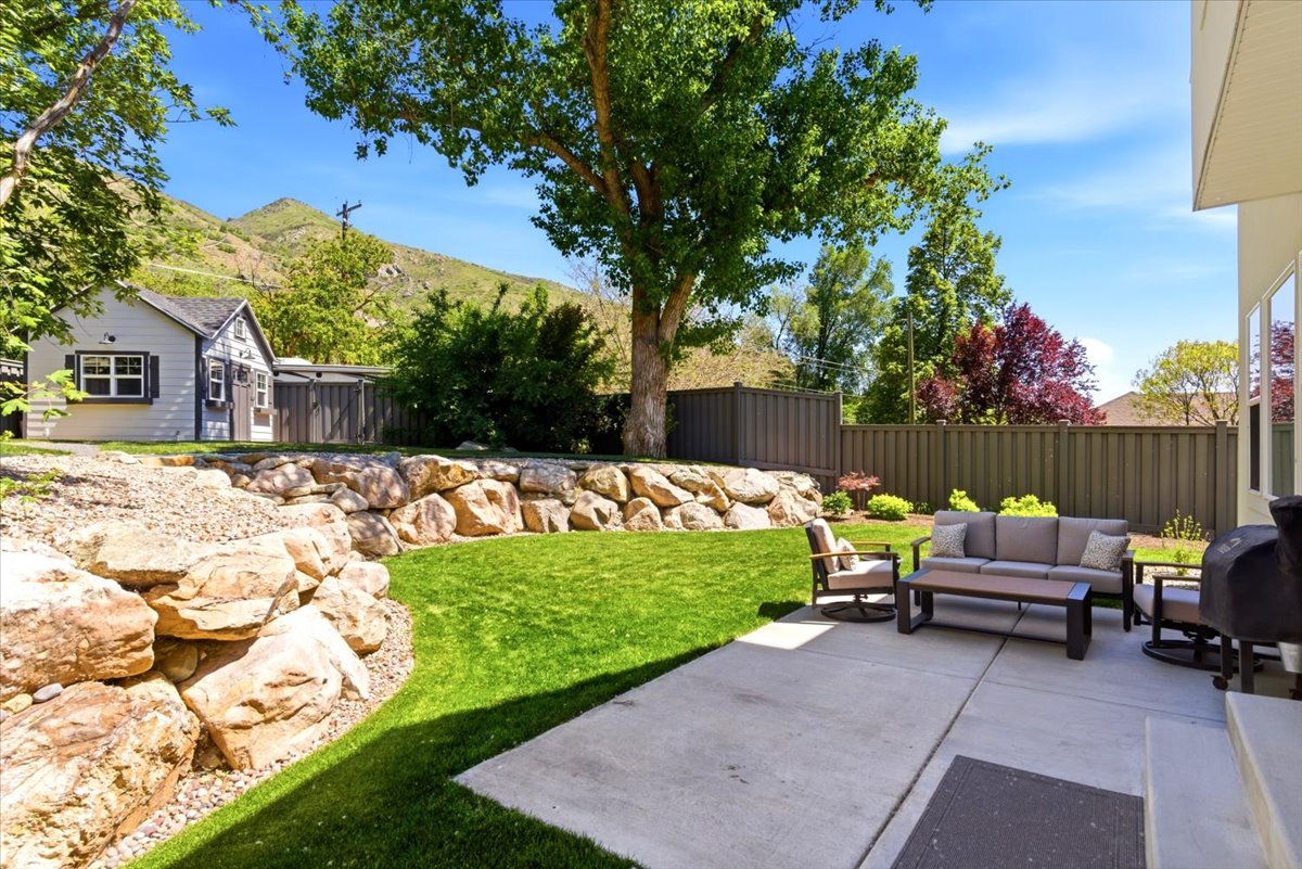 Expansive concrete patio with multiple windows overlooking the space