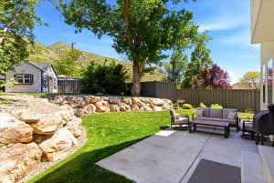 Expansive concrete patio with multiple windows overlooking the space