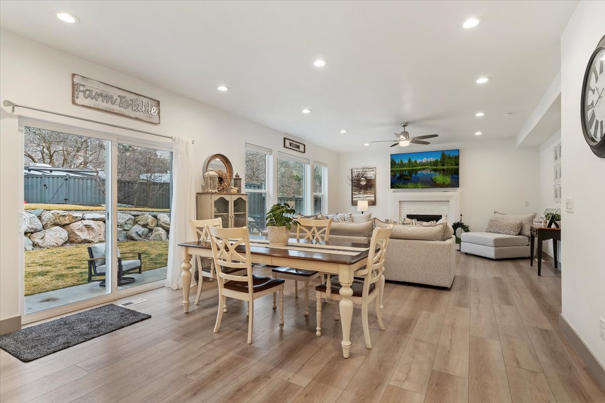 Expansive open-concept living area featuring wood-finish flooring, recessed lighting, and a ceiling fan