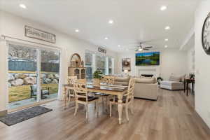 Expansive open-concept living area featuring wood-finish flooring, recessed lighting, and a ceiling fan