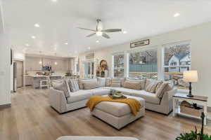 Open-concept living area featuring light wood-finish flooring and recessed lighting throughout