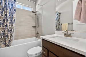 Bathroom featuring a built-in bathtub with subway tile surround, integrated shower niche, and a window above