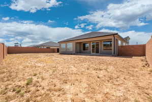 Expansive rear yard featuring concrete block perimeter fencing